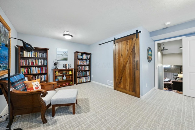 6767 Burnside Ln, Dublin, OH 43016 - sitting room with visible vents, a barn door, carpet flooring, and baseboards