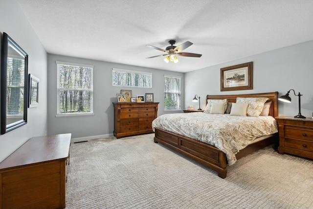 6767 Burnside Ln, Dublin, OH 43016 - bedroom featuring a ceiling fan, visible vents, baseboards, a textured ceiling, and light colored carpet