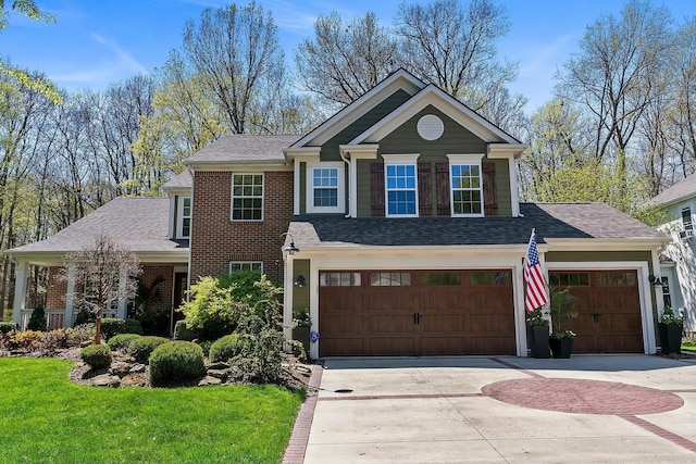 6767 Burnside Ln, Dublin, OH 43016 - view of front of property with a front yard, driveway, a shingled roof, and brick siding