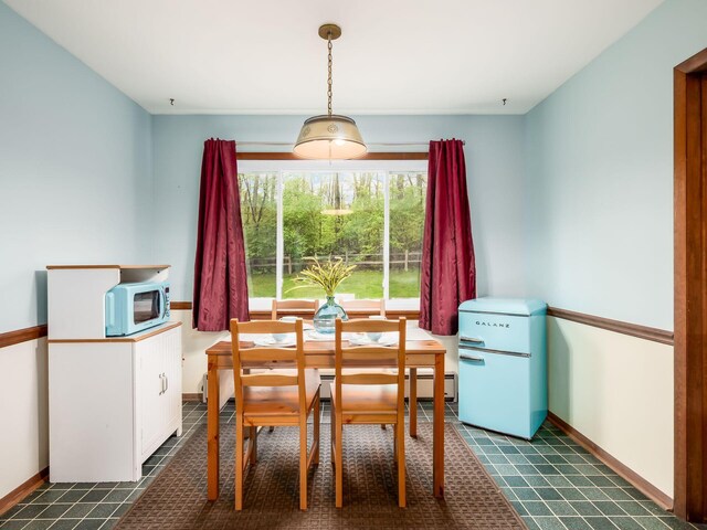dining space featuring baseboards