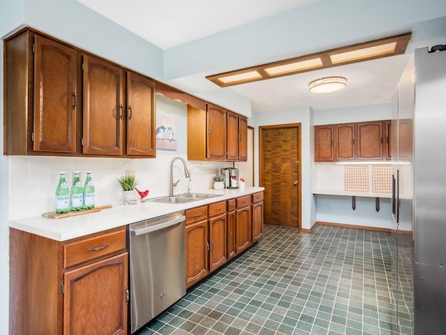 kitchen featuring stainless steel dishwasher, decorative backsplash, a sink, and light countertops