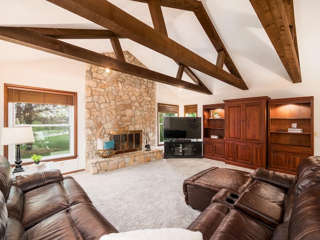 living area featuring beamed ceiling, plenty of natural light, and carpet
