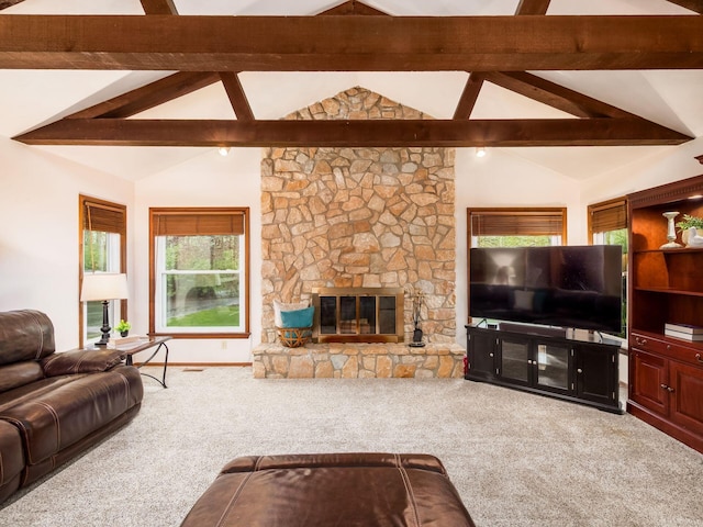 living room with vaulted ceiling with beams, carpet, plenty of natural light, and a fireplace