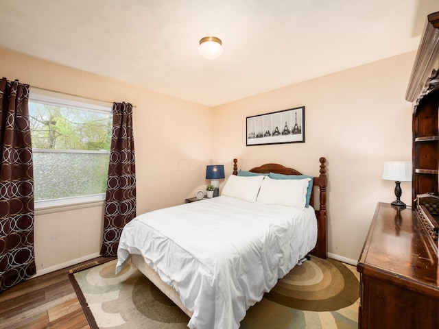 bedroom featuring baseboards and wood finished floors