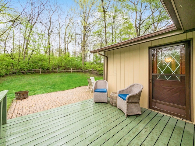 wooden terrace with a yard, a patio, fence, and an outdoor fire pit