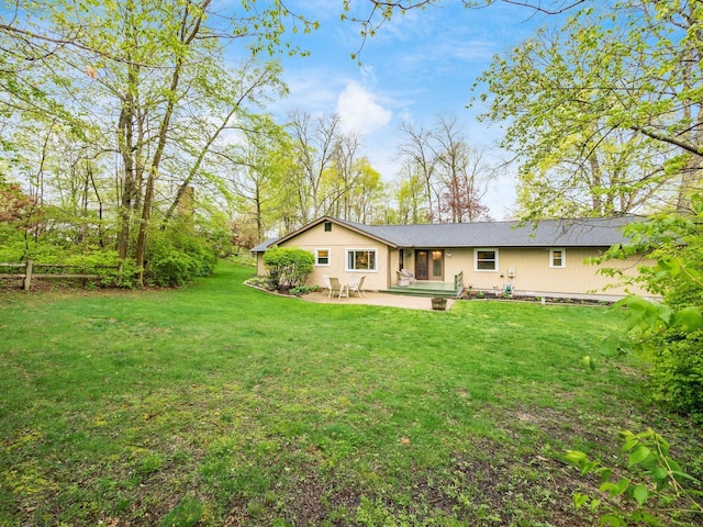 back of house featuring a patio area and a yard