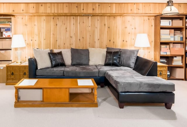 living area with wooden walls and carpet floors