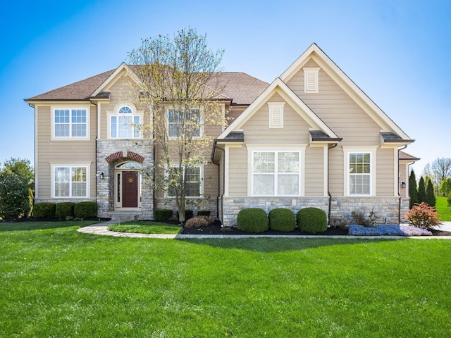 view of front of property featuring a front yard and stone siding