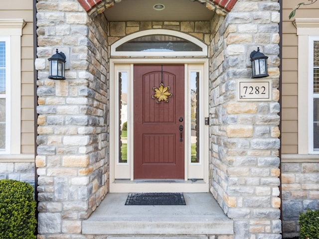 view of exterior entry featuring stone siding