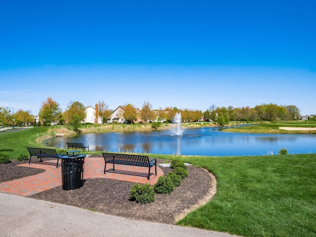 view of community featuring a lawn and a water view