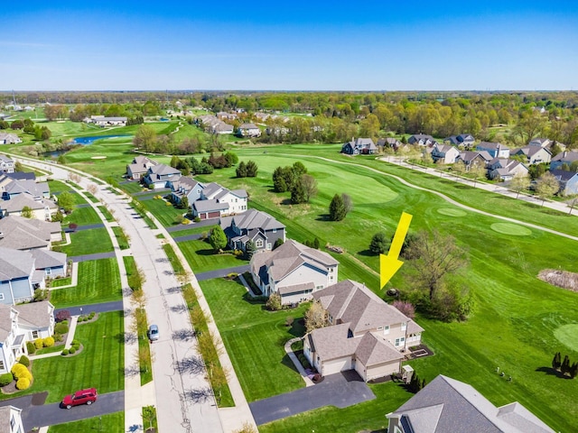 drone / aerial view with a residential view, view of golf course, and a water view