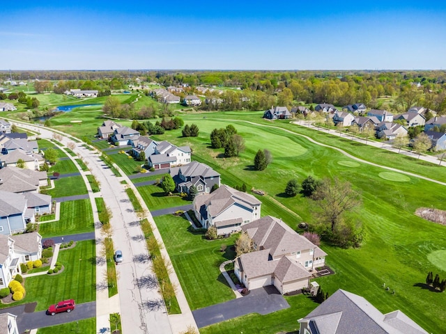 drone / aerial view featuring a residential view, view of golf course, and a water view