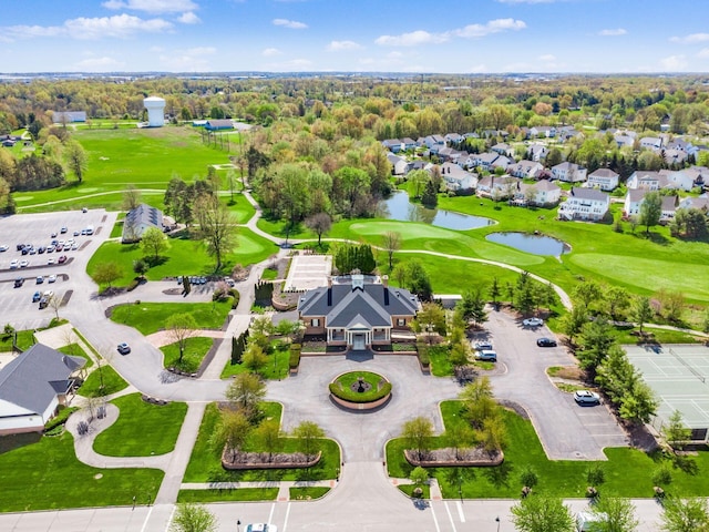 bird's eye view with a water view, view of golf course, and a residential view