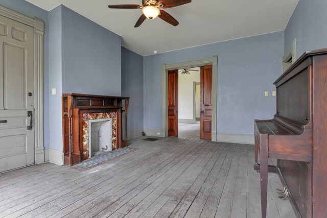 423 Hudson Ave, Newark, OH 43055 - unfurnished living room with wood-type flooring, ceiling fan, baseboards, and a fireplace