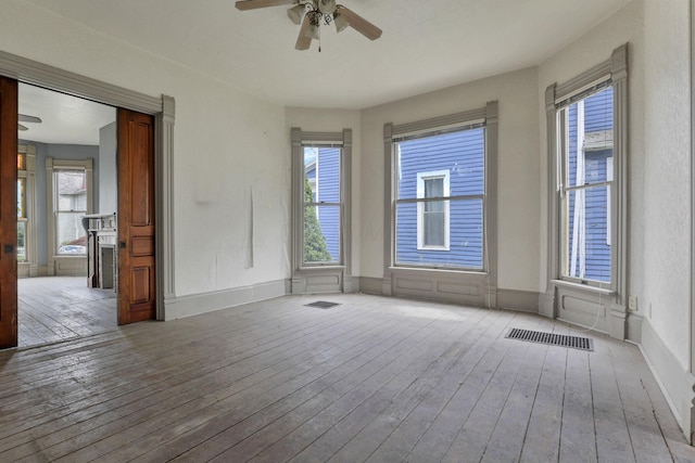423 Hudson Ave, Newark, OH 43055 - unfurnished room featuring ceiling fan, baseboards, hardwood / wood-style flooring, and plenty of natural light