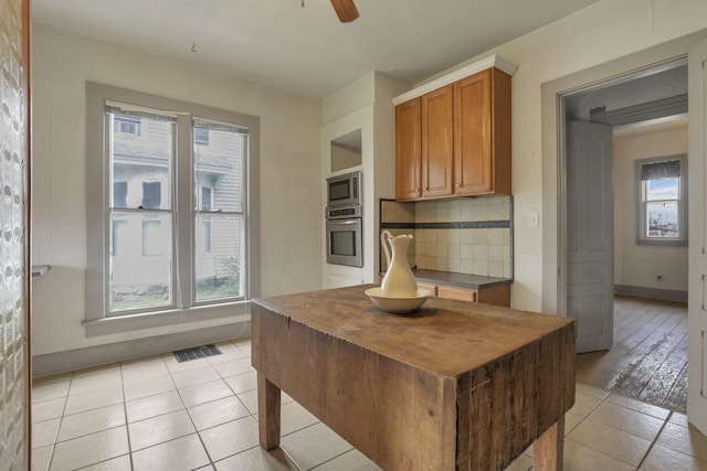 423 Hudson Ave, Newark, OH 43055 - kitchen featuring stainless steel appliances, backsplash, ceiling fan, visible vents, and light tile patterned flooring