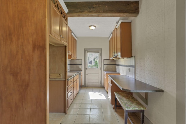 423 Hudson Ave, Newark, OH 43055 - kitchen with light tile patterned floors, dark countertops, brown cabinets, and beamed ceiling