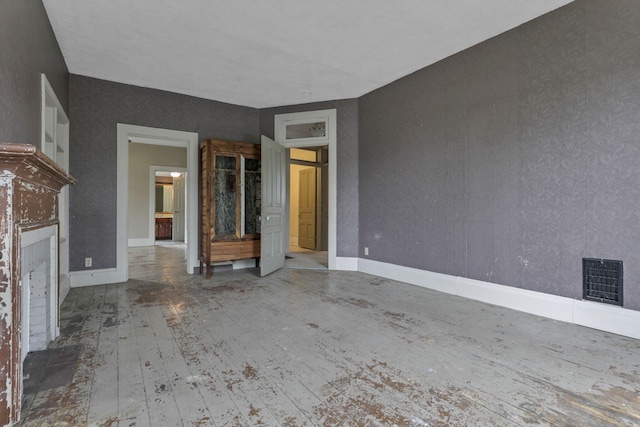 423 Hudson Ave, Newark, OH 43055 - unfurnished living room with a fireplace, visible vents, hardwood / wood-style flooring, and baseboards