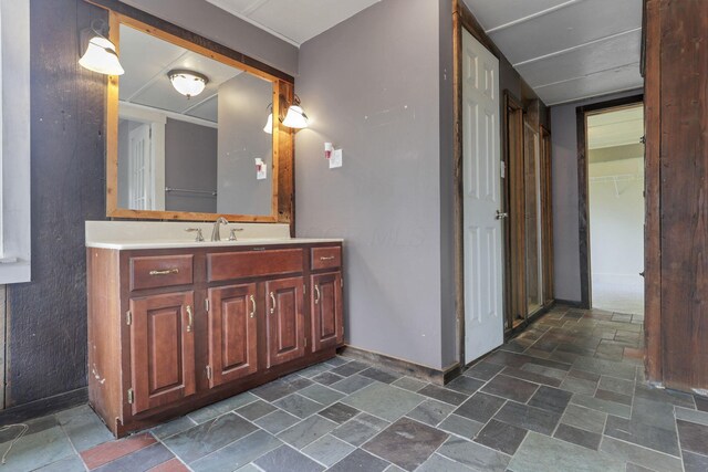 423 Hudson Ave, Newark, OH 43055 - bathroom with baseboards, stone tile flooring, a closet, and vanity