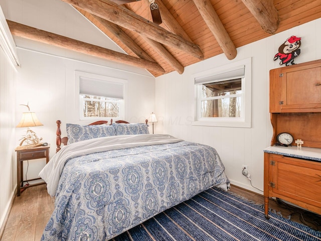 bedroom with vaulted ceiling with beams, multiple windows, wood ceiling, and wood finished floors