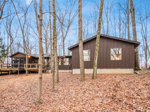 view of home's exterior featuring a wooden deck and a sunroom