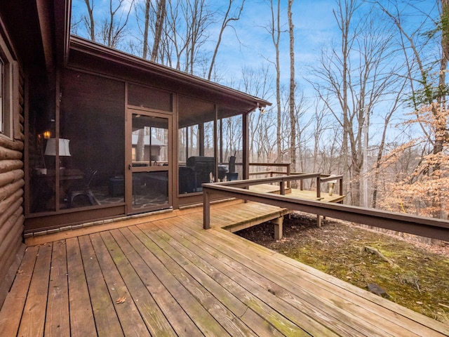 wooden deck featuring a sunroom
