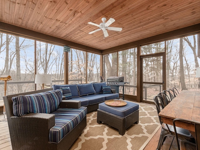 sunroom / solarium featuring ceiling fan and an outdoor hangout area