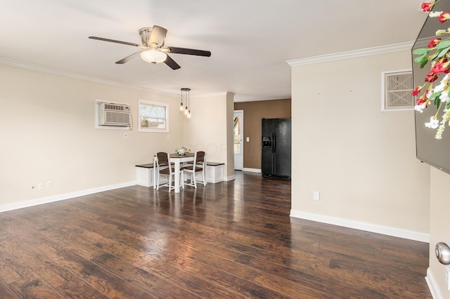 dining room with a ceiling fan, a wall unit AC, ornamental molding, and wood finished floors