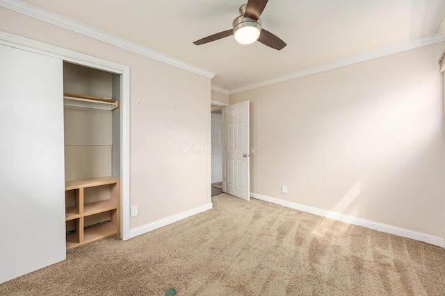 unfurnished bedroom featuring ceiling fan, crown molding, baseboards, a closet, and carpet