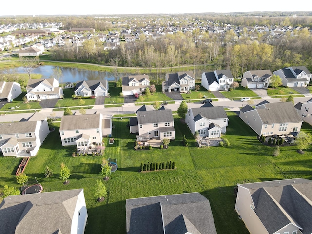 drone / aerial view with a residential view and a water view