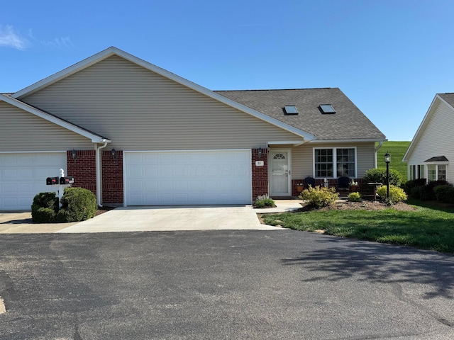 view of front of house with brick siding, an attached garage, and concrete driveway