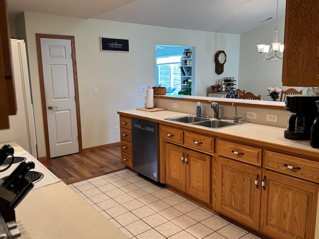 kitchen featuring brown cabinetry, freestanding refrigerator, light countertops, a sink, and dishwasher