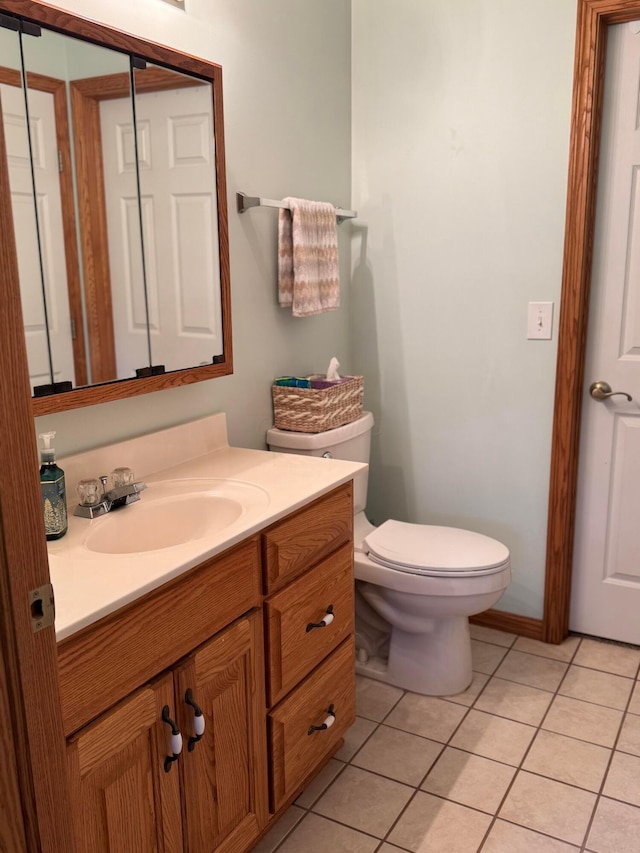 bathroom featuring toilet, tile patterned floors, and vanity