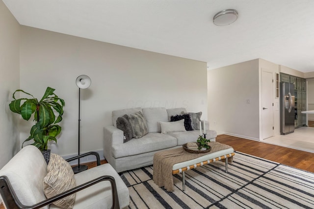 living room featuring baseboards and light wood-type flooring
