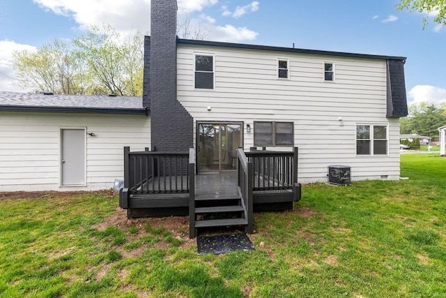 rear view of property featuring a lawn, a wooden deck, a chimney, and cooling unit