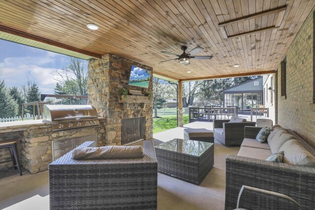 view of patio with ceiling fan, area for grilling, an outdoor living space, and a grill