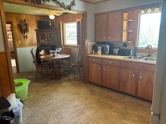 5398 Marietta Rd SE, New Lexington, OH 43764 - kitchen featuring open shelves, a sink, wood walls, and a wealth of natural light
