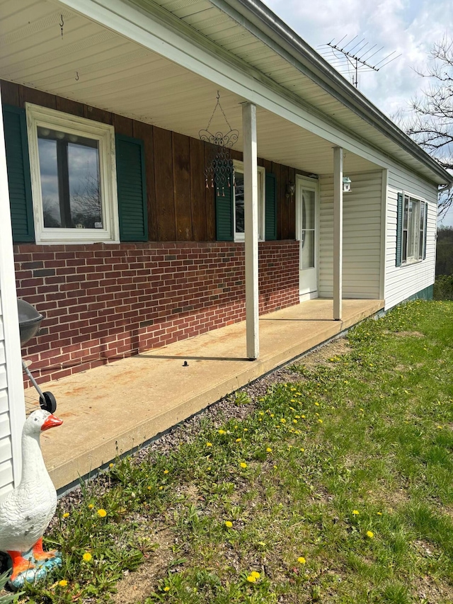 5398 Marietta Rd SE, New Lexington, OH 43764 - view of side of home featuring covered porch, board and batten siding, and brick siding
