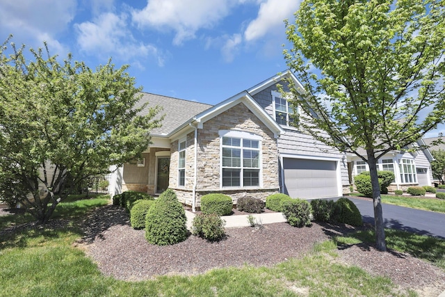 craftsman house featuring driveway and stone siding