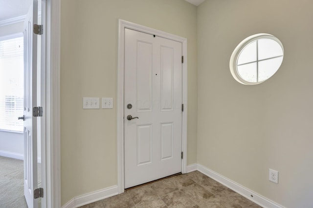 entrance foyer featuring baseboards and a healthy amount of sunlight