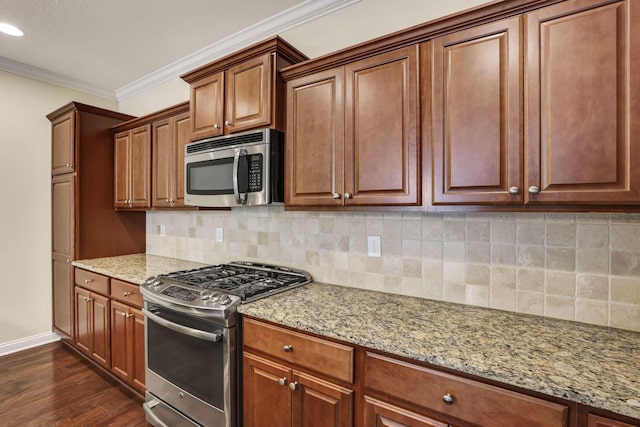kitchen featuring light stone countertops, baseboards, dark wood-type flooring, appliances with stainless steel finishes, and backsplash