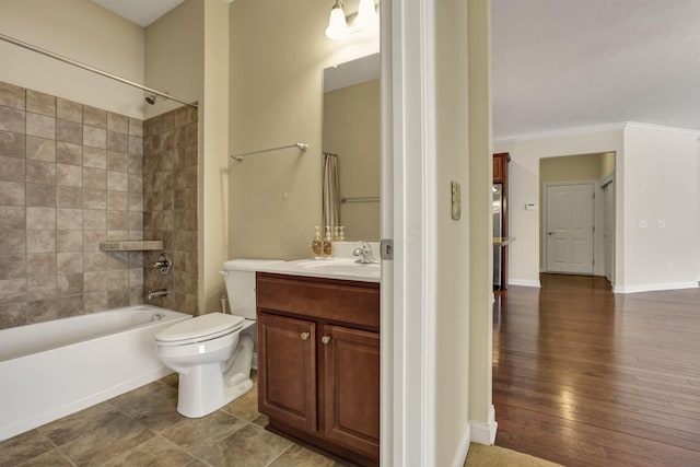 full bath with toilet, shower / washtub combination, wood finished floors, and vanity