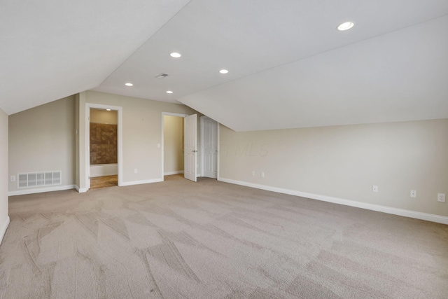 bonus room with light colored carpet, recessed lighting, baseboards, lofted ceiling, and visible vents