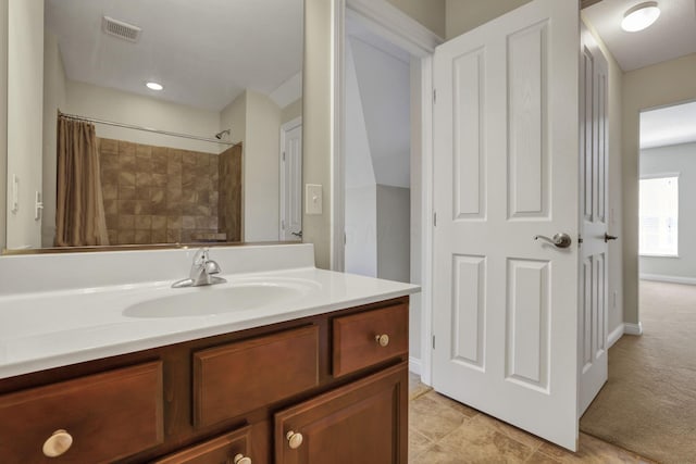 bathroom featuring vanity, curtained shower, and visible vents