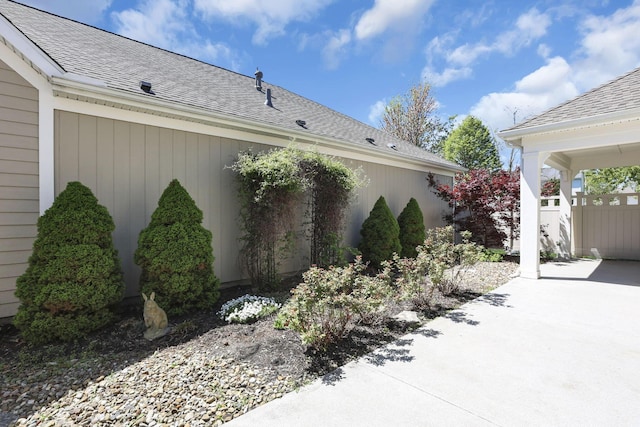 view of side of property with a shingled roof