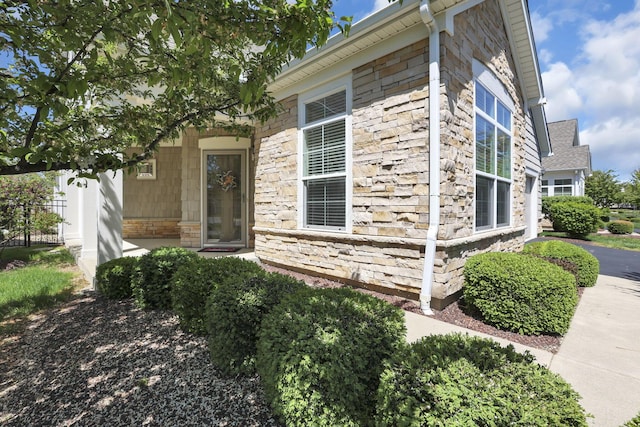 view of property exterior with stone siding