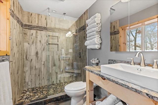 full bath featuring a walk in shower, vanity, and toilet