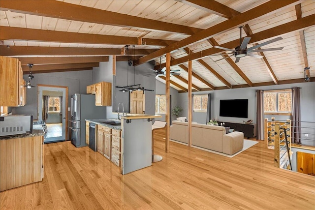 kitchen featuring a sink, vaulted ceiling with beams, a ceiling fan, and dishwasher