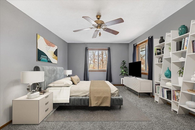 carpeted bedroom with baseboards, a ceiling fan, and a textured ceiling