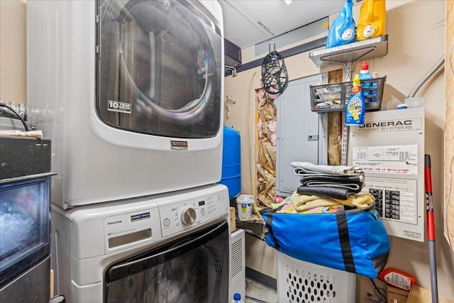 clothes washing area with stacked washer / drying machine and laundry area